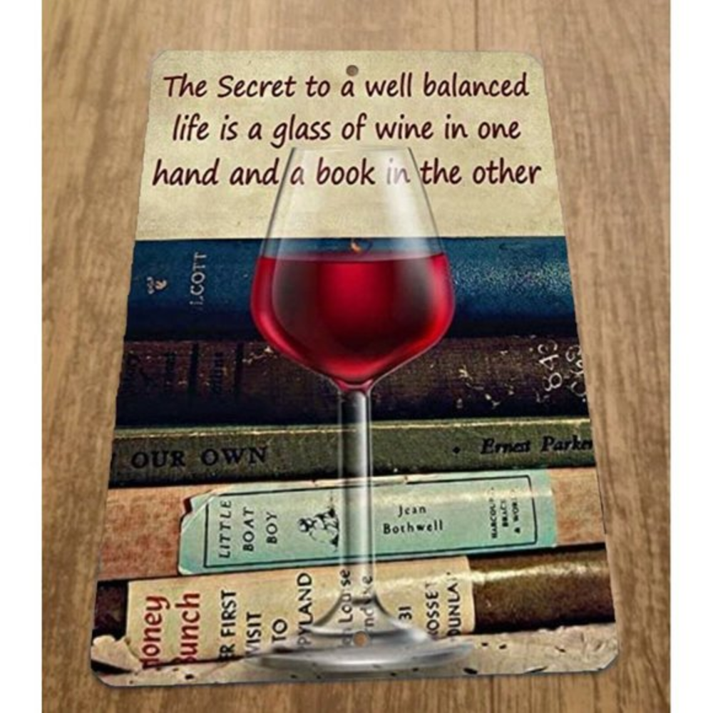 The Secret to a well balanced life is a glass of wine and a book 8x12 Metal Sign